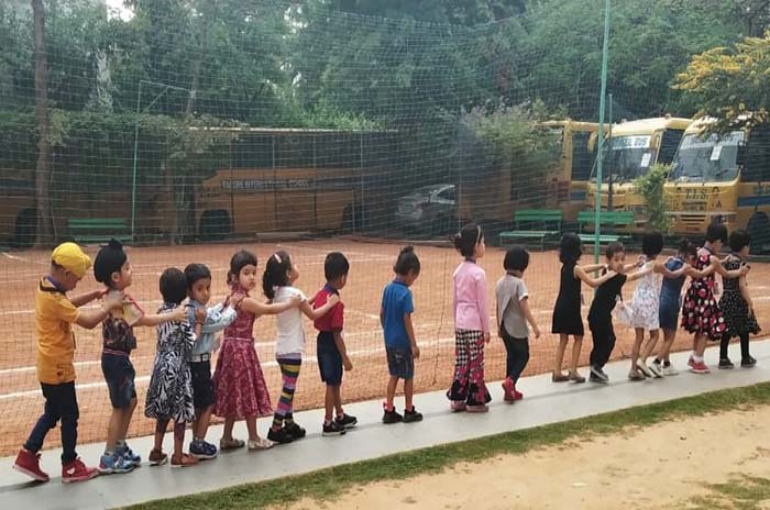 children walking in a straight line